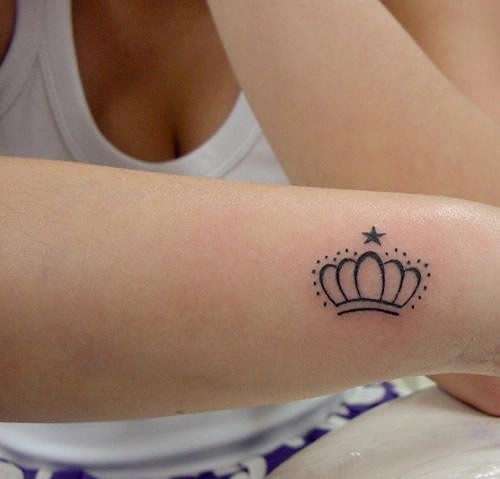 Circled crown tattoo on the arm