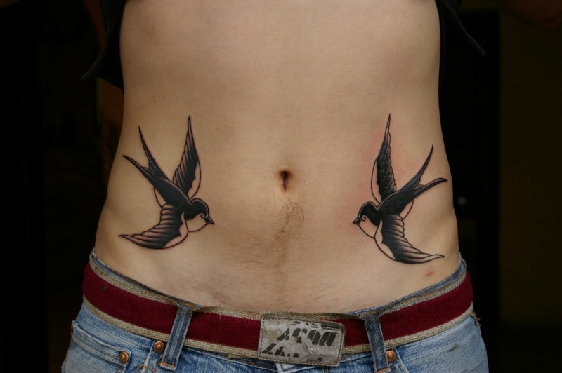 Classic swallow birds tattoo on man's belly