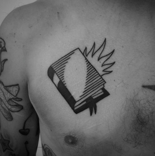 Closed book with bookmark and flames black and white chest tattoo in old school style