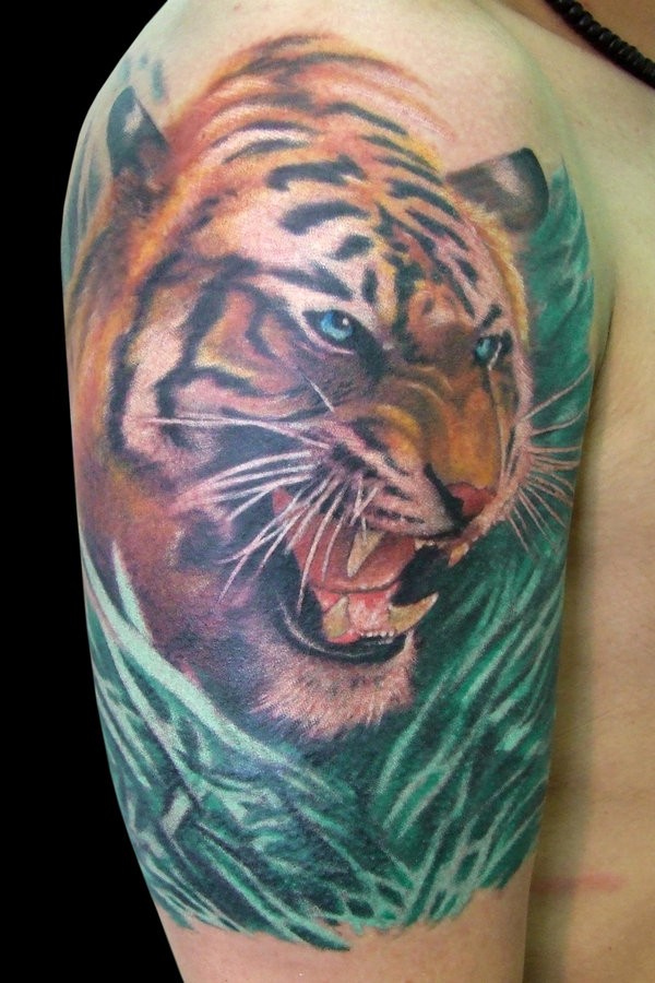 Colored detailed tiger in greens tattoo
