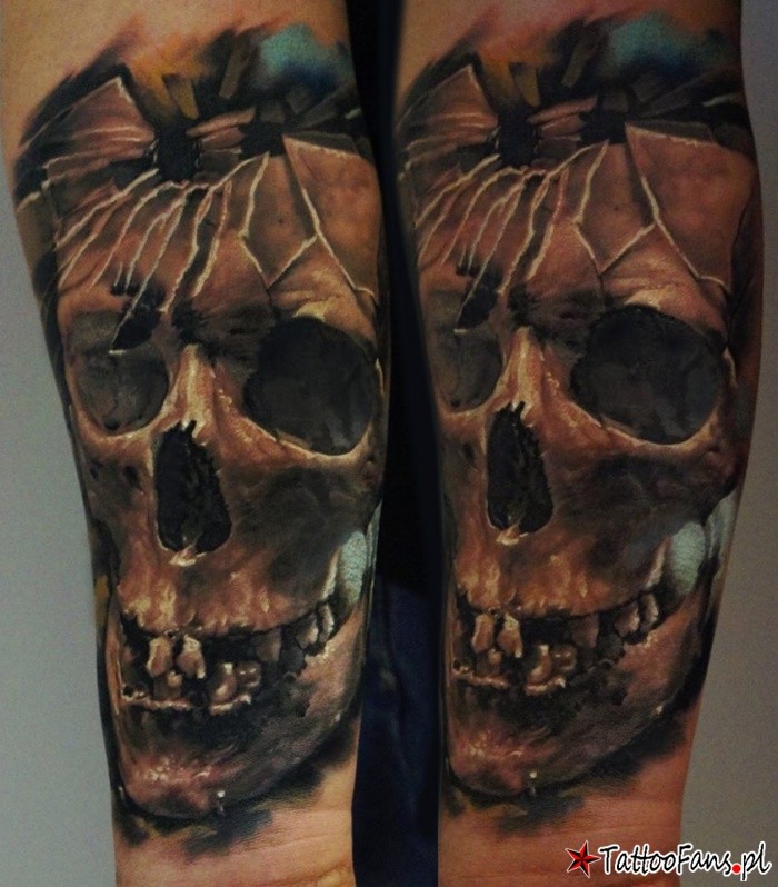 Colored amazing looking arm tattoo of broken human skull