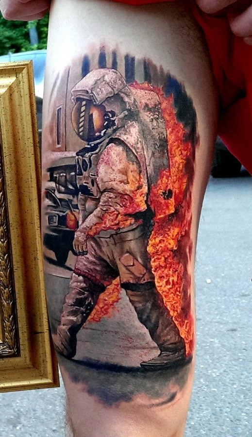 Colored amazing looking arm tattoo of burning astronaut