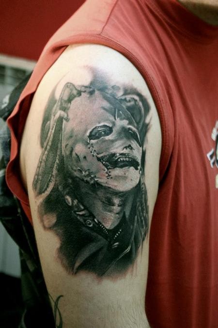 Colored amazing looking shoulder tattoo of famous band singer