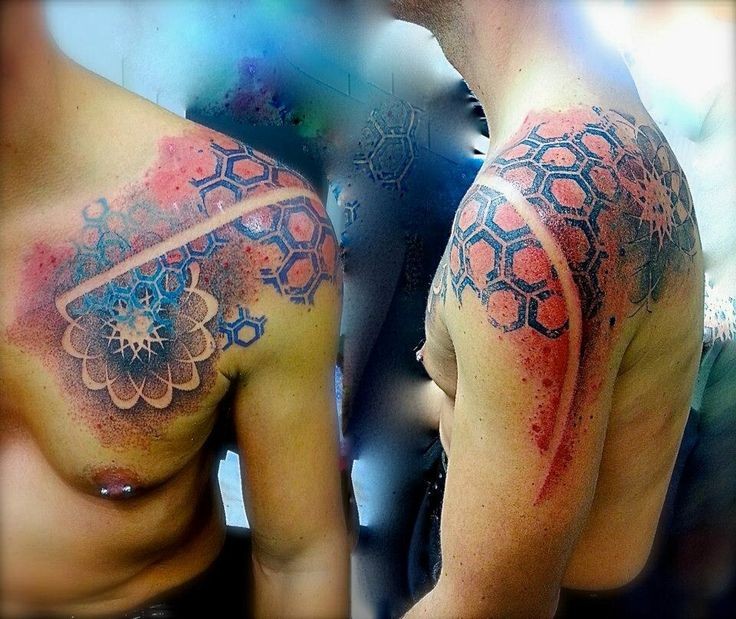 Colored and detailed chest and shoulder tattoo of ancient ornaments