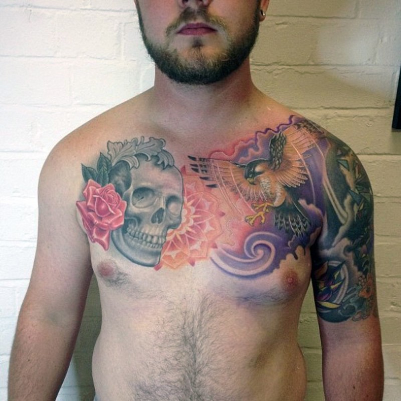 Colored big skull with flowers tattoo on chest combined with flying eagle