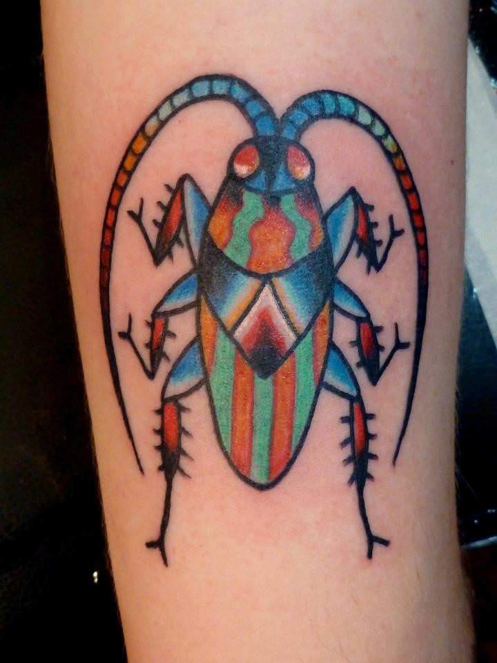 Colored bug tattoo on arm