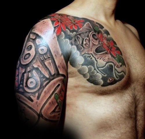 Colored chest and shoulder tattoo of of ancient tribe statues and flowers