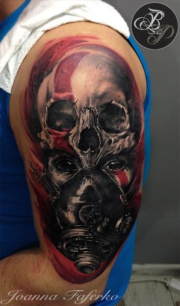 Colored creepy looking shoulder tattoo of tribal woman with gas mask