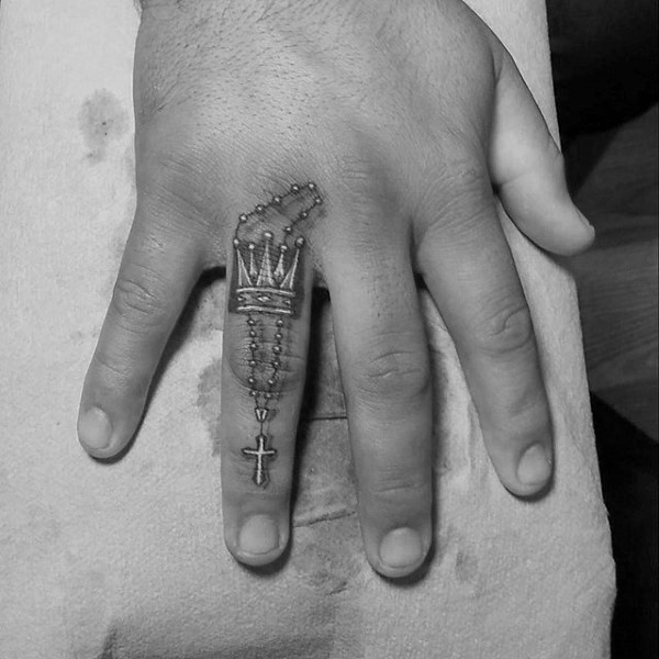 Colored finger tattoo of crown with cross