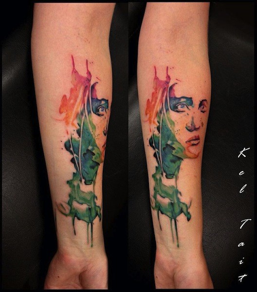 Colored forearm tattoo of abstract style woman portrait