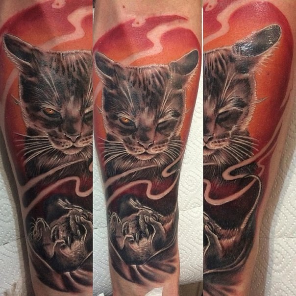 Colored forearm tattoo of cat with demonic hand