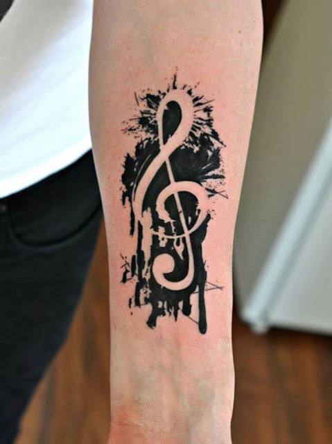 Colored forearm tattoo of small music symbol