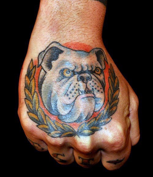 Colored hand tattoo of creepy dog with feather