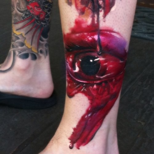 Colored horror style ankle tattoo of bloody eye