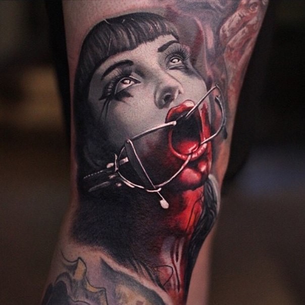 Colored horror style colored arm tattoo of bloody creepy woman face