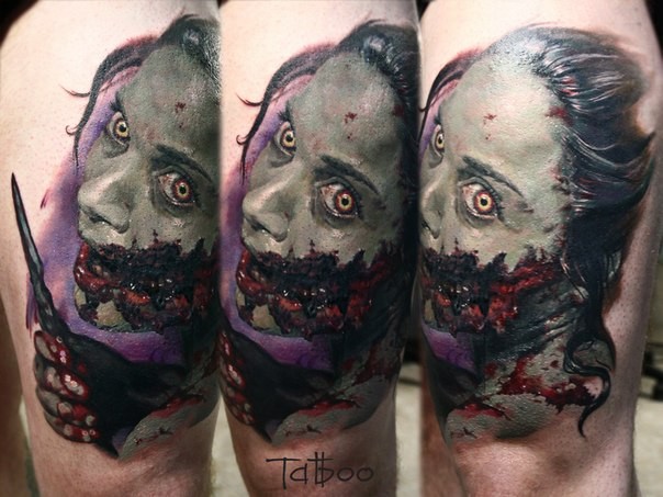 Colored horror style colored thigh tattoo of bloody zombie woman with knife