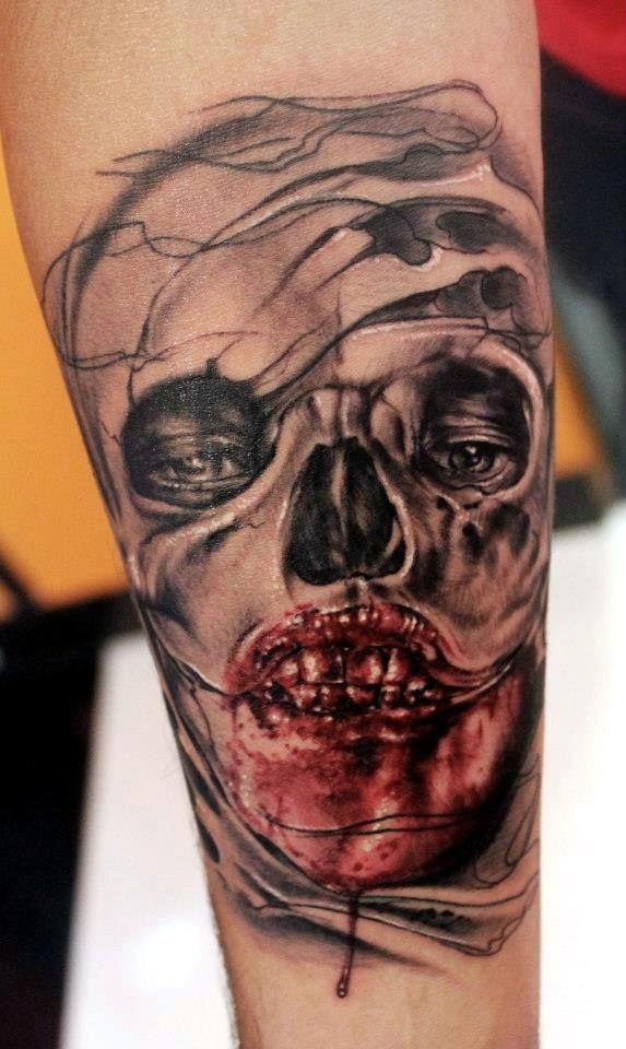 Colored horror style creepy looking arm tattoo of monster face with bloody face