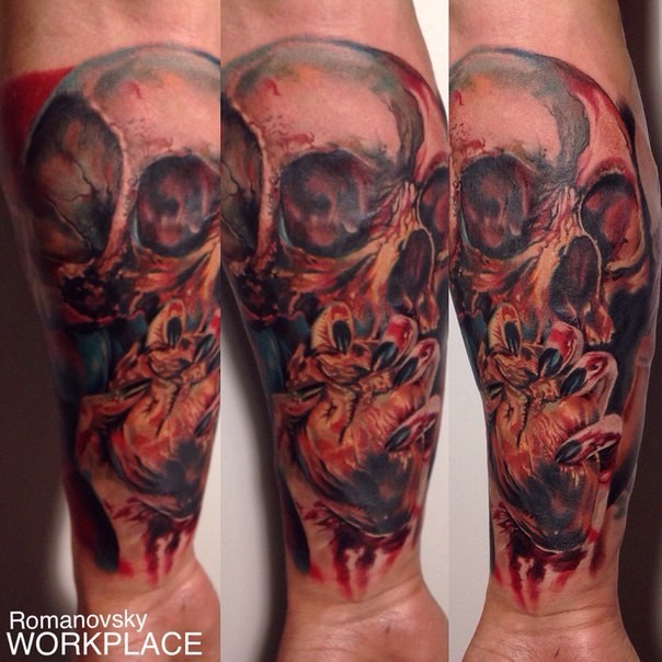 Colored horror style creepy looking forearm tattoo of human skull and heart