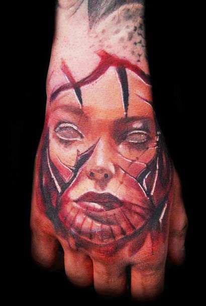 Colored horror style creepy looking hand tattoo of woman face