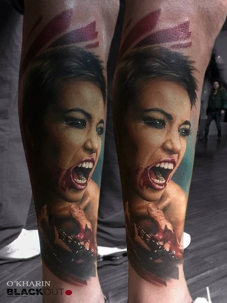 Colored horror style creepy looking leg tattoo of bloody woman face