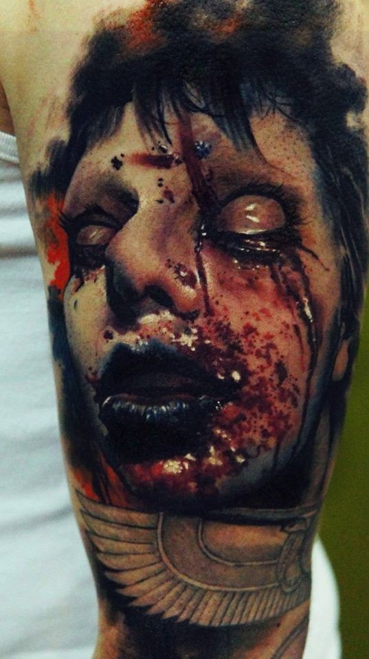 Colored horror style creepy looking tattoo of bloody humans face