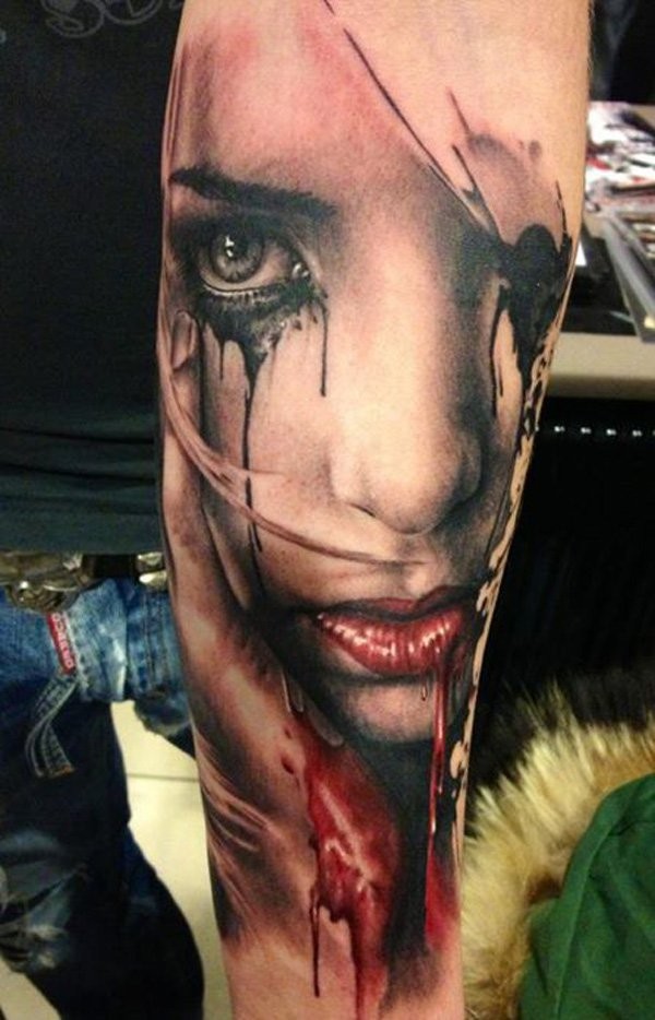 Colored horror style large bloody woman portrait tattoo on forearm