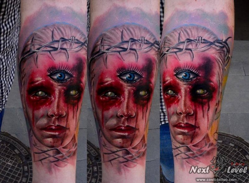 Colored horror style medium size forearm tattoo fo bloody woman with three eyes