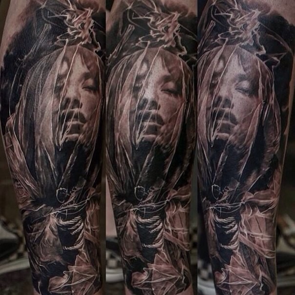 Colored horror style woman portrait tattoo on arm