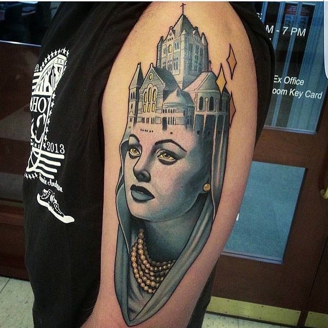 Colored interesting looking shoulder tattoo of woman with cathedral and stars