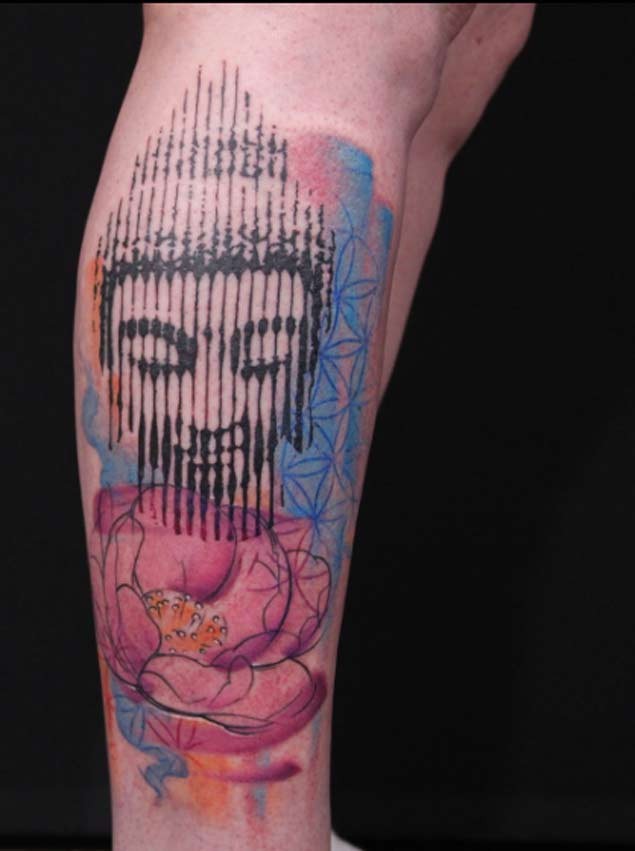 Colored leg tattoo of Buddha statue with flowers