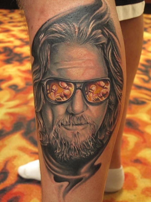 Colored leg tattoo of man portrait in sun glasses