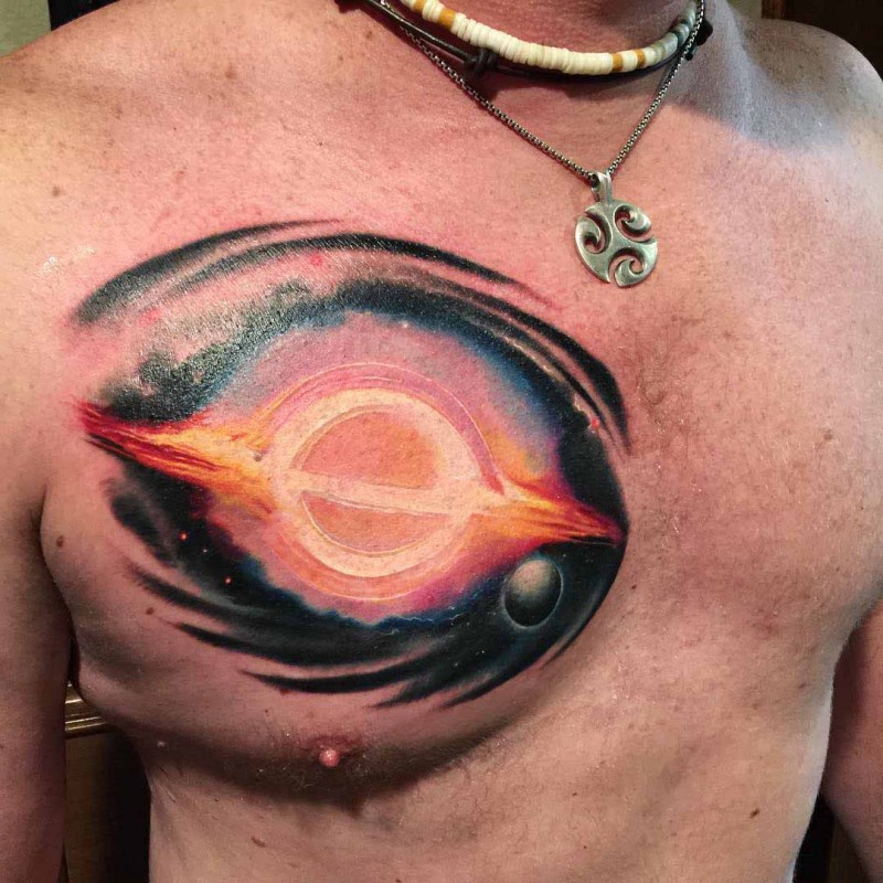 Colored marvelous looking chest tattoo of big planet blast