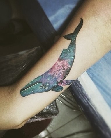 Colored medium size whale tattoo on arm in futuristic style