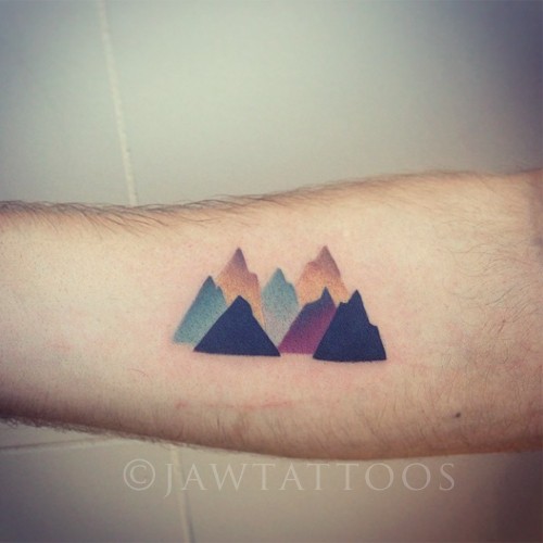 Colored mountain scenery designed tattoo on forearm