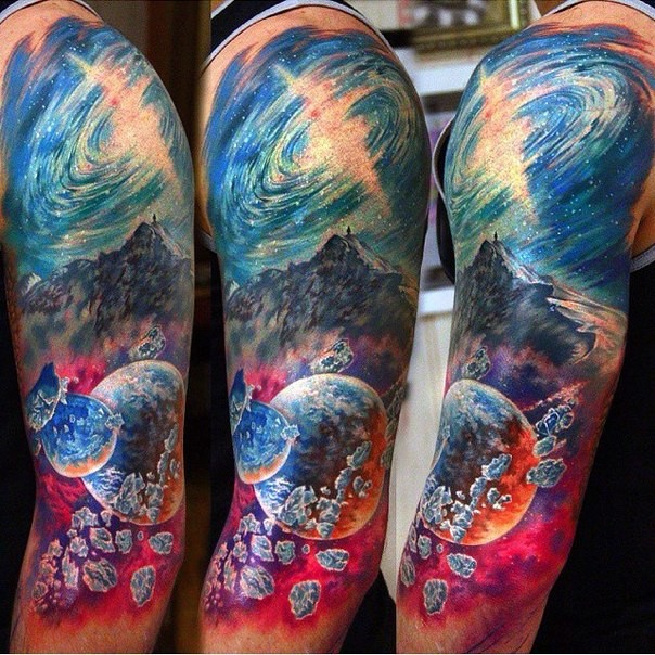 Colored mysterious looking shoulder tattoo of night sky with mountain