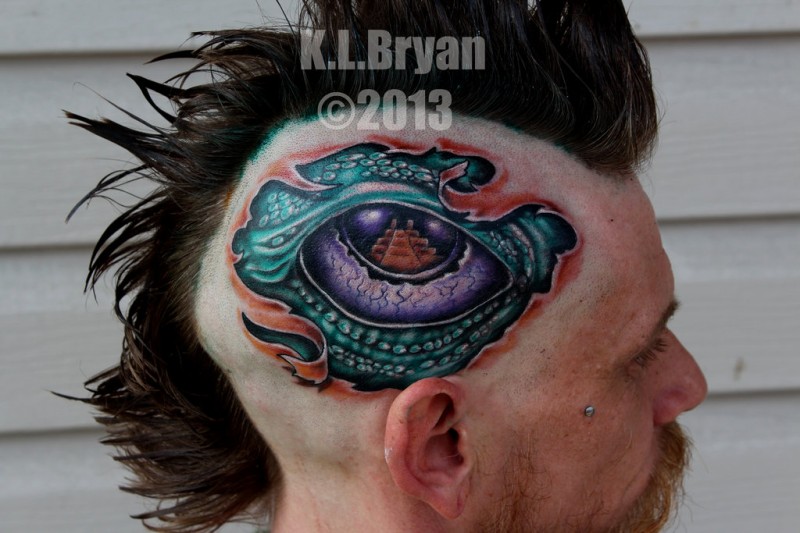 Colored new school style head tattoo of dragon eye
