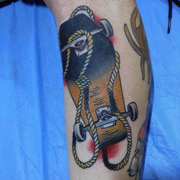 Colored old school style roped skateboard tattoo on arm