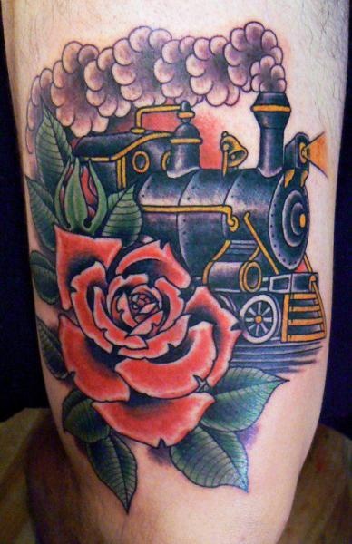 Colored old school style steaming train with big red rose tattoo on arm