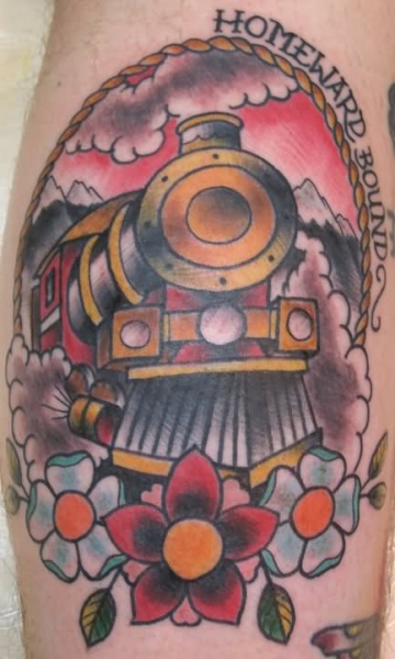 Colored portrait style leg tattoo of steam train with lettering and flower