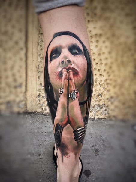 Colored realism style leg tattoo of Merlin Manson portrait