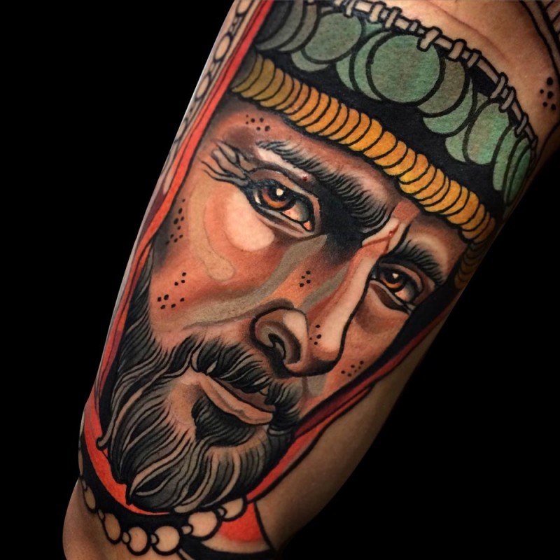 Colored realistic looking arm tattoo of sad man face