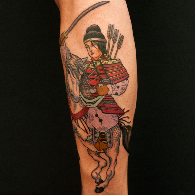 Colored samurai on horseback tattoo on leg