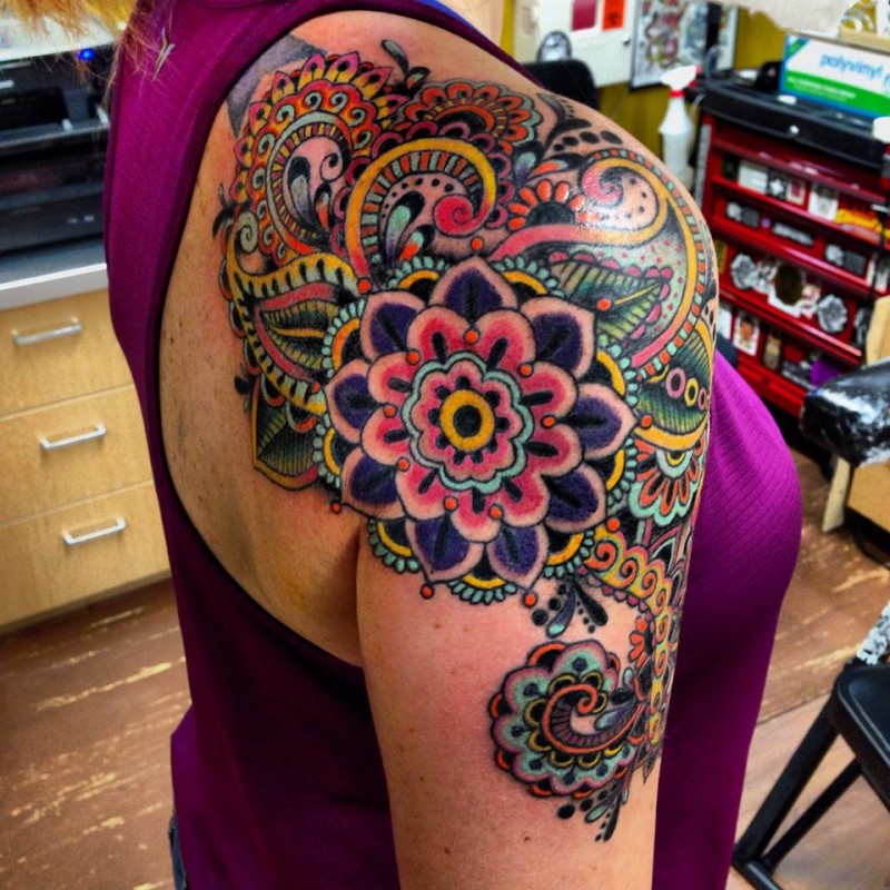Colored shoulder tattoo of big beautiful flowers