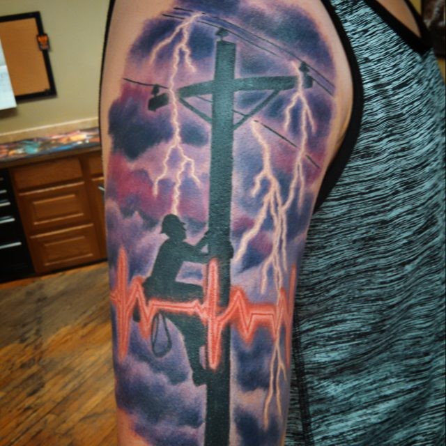 Colored shoulder tattoo of big picture of lineman with lightning