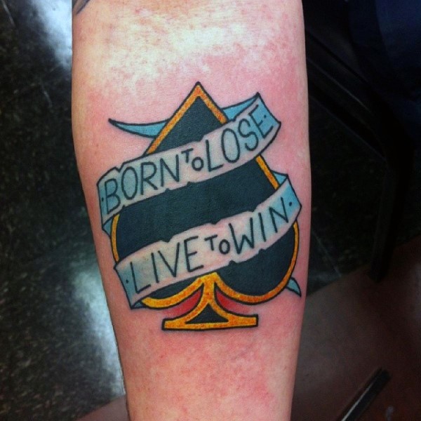 Colored spades symbol with optimistic lettering on banner tattoo