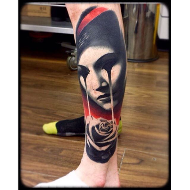 Colored surrealism style leg tattoo of creepy woman with rose