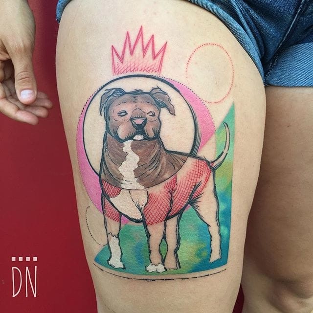 Colored thigh tattoo of dog with crown