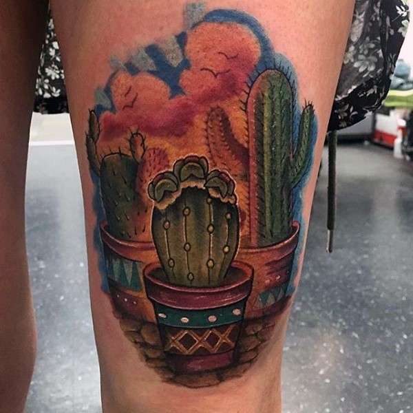 Colored thigh tattoo of natural looking cactus in pot