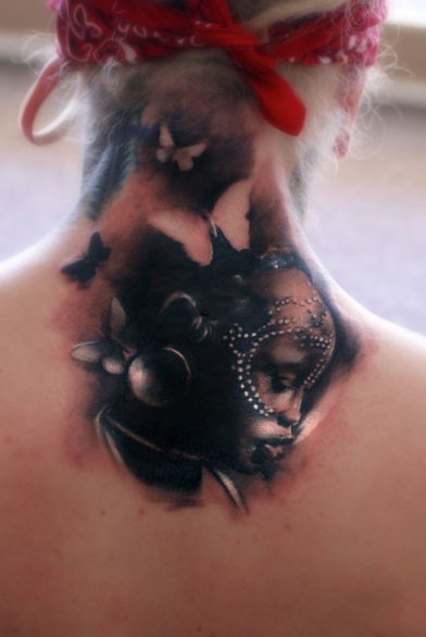 Colored upper back tattoo of tribal woman face with butterflies