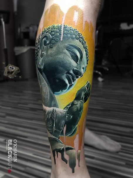 Colored very detailed Buddha statue tattoo on leg